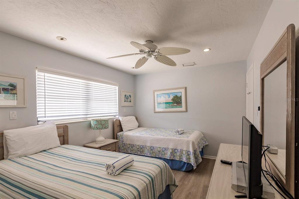 6020 Midnight Pass Road, Unit 59 Sarasota, FL 34242 - Photo 9 of 12 a bedroom with two beds and a window
