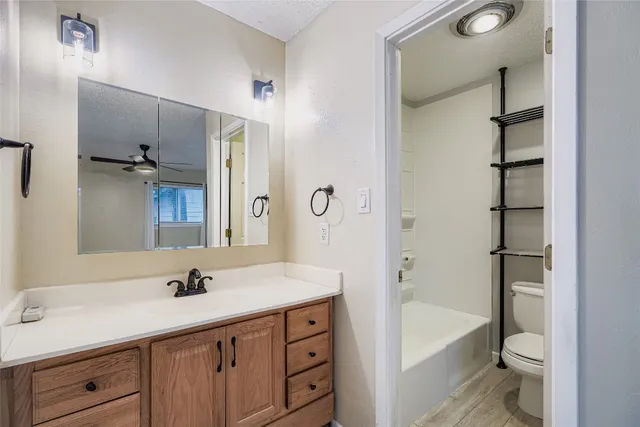 a bathroom with a double vanity sink toilet mirror and bathtub
