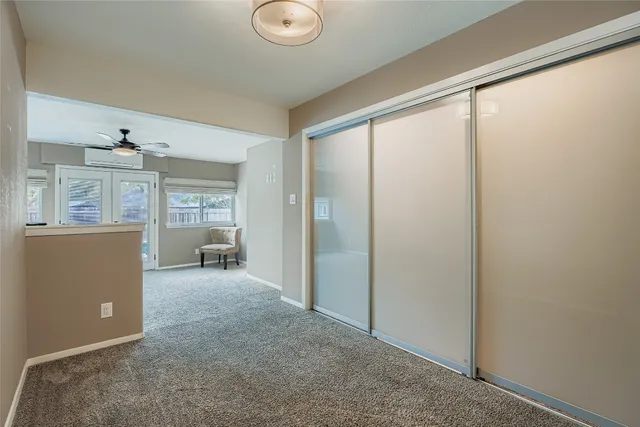 a view of a livingroom with a piano and wooden floor