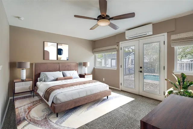 a bedroom with a large bed and a chandelier