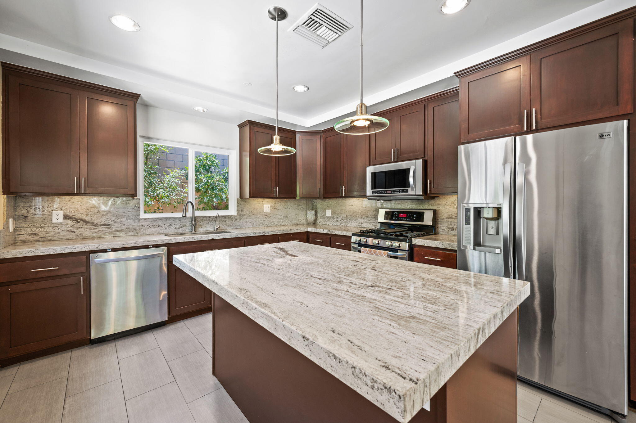 5905 Old Wheeler Road La Verne, CA 91750 - Photo 18 of 81 a kitchen with stainless steel appliances granite countertop counter space a sink refrigerator and microwave