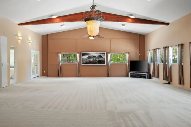 a view of a backyard with table and chairs and wooden fence