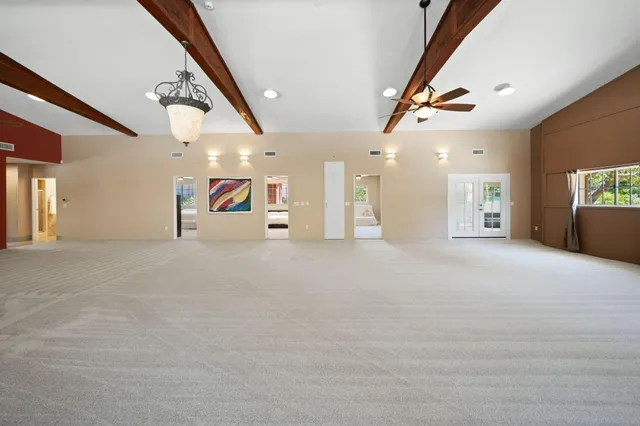 an aerial view of a house with a yard and lake view