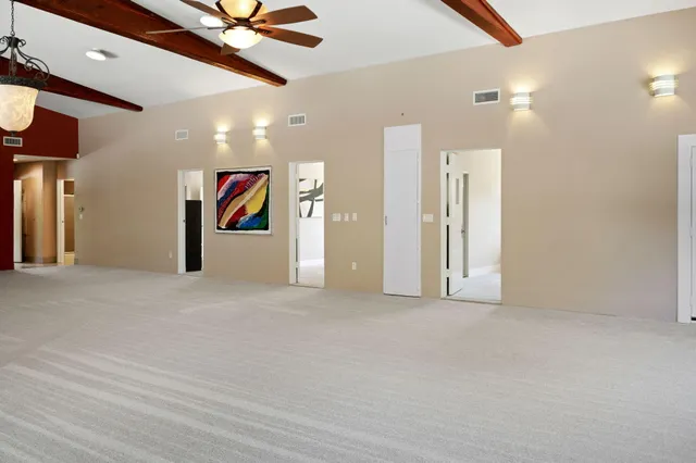 an aerial view of a house with a yard and floor to ceiling window