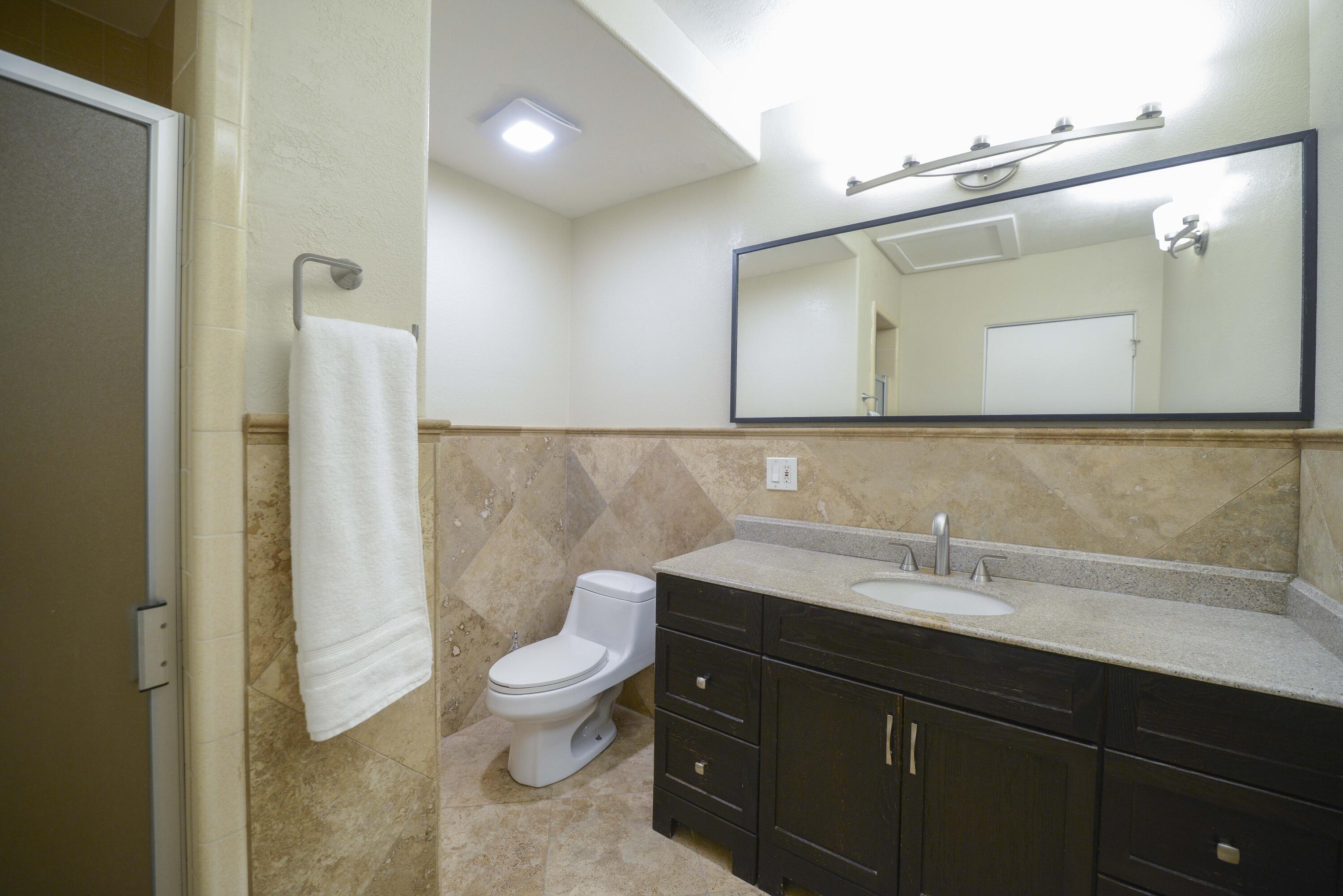 5905 Old Wheeler Road La Verne, CA 91750 - Photo 54 of 81 a bathroom with a sink a toilet and a mirror