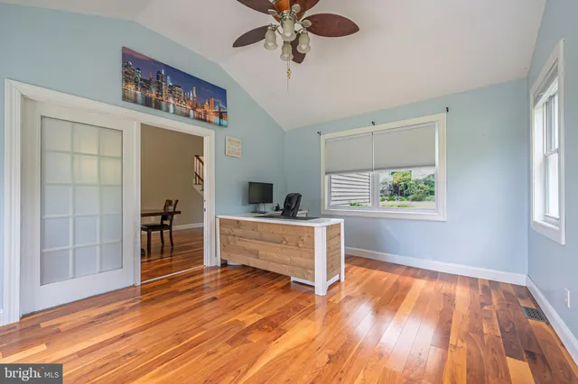 a view of workspace with wooden floor and windows