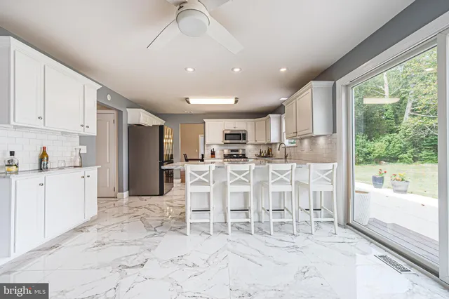 a kitchen with stainless steel appliances granite countertop a refrigerator and cabinets