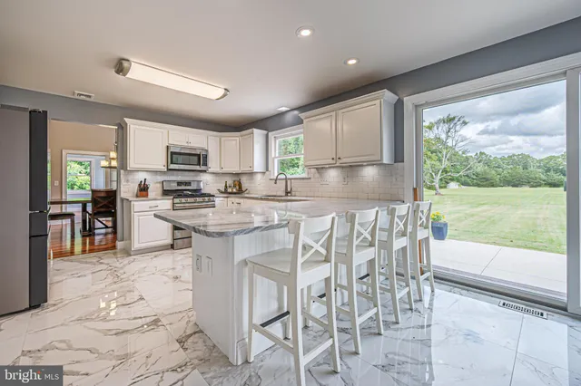 a kitchen with white cabinets and appliances
