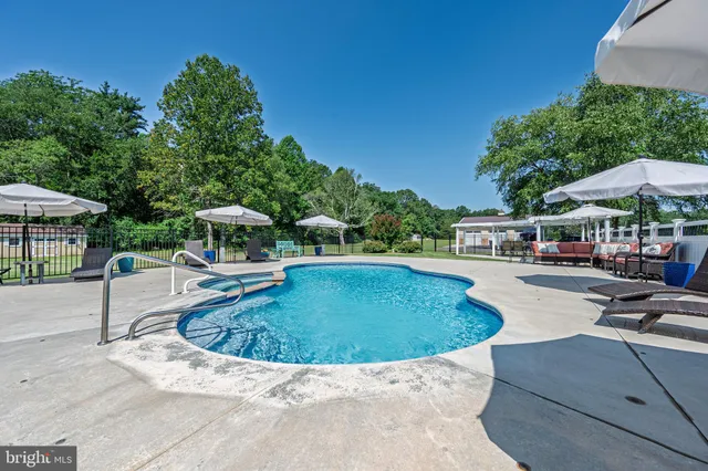 a swimming pool with outdoor seating and yard