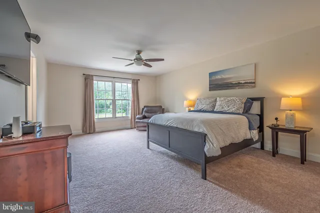 a bathroom with a tub a double vanity sink and mirror
