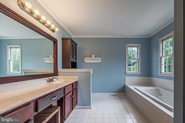 a spacious bathroom with a double vanity sink and a mirror