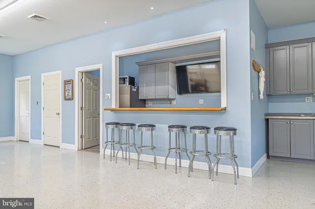 a kitchen with stainless steel appliances granite countertop a sink a stove and cabinets