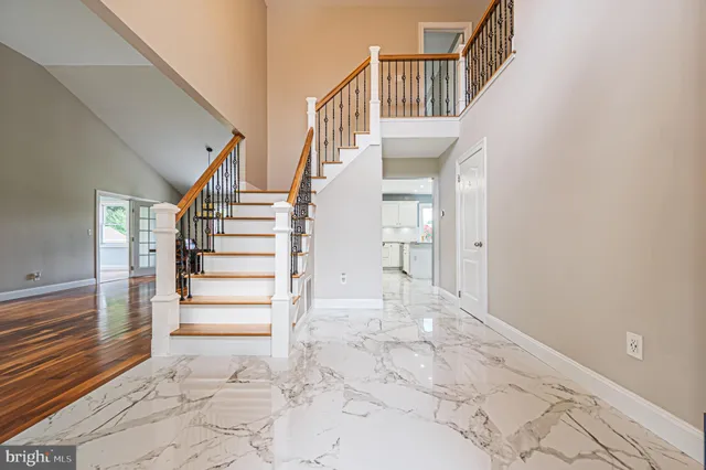 a view of entryway and hall with a front door