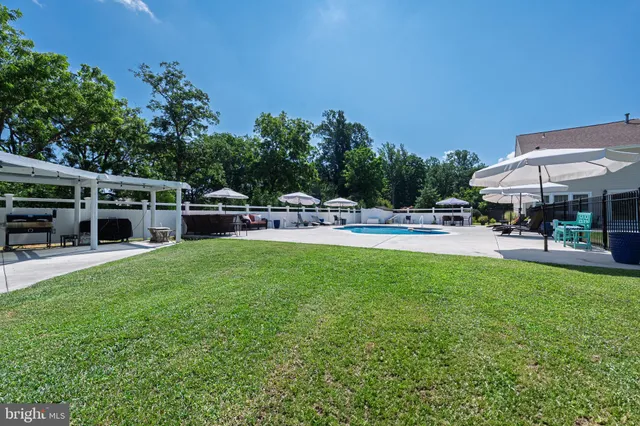 a view of a house with backyard sitting area and garden