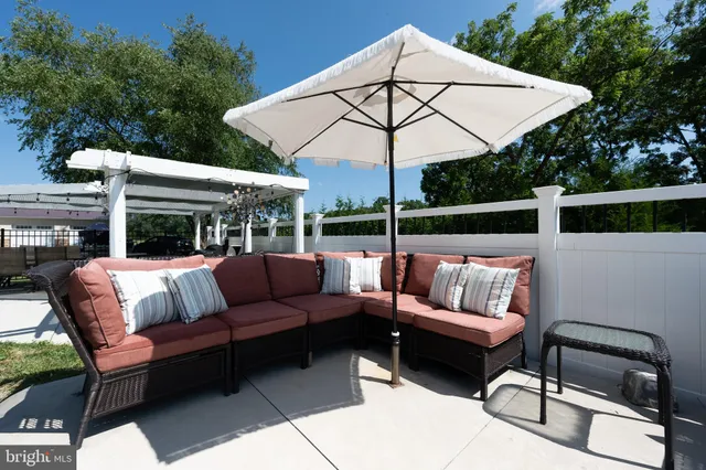 a view of a house with a big yard and potted plants in front of the house