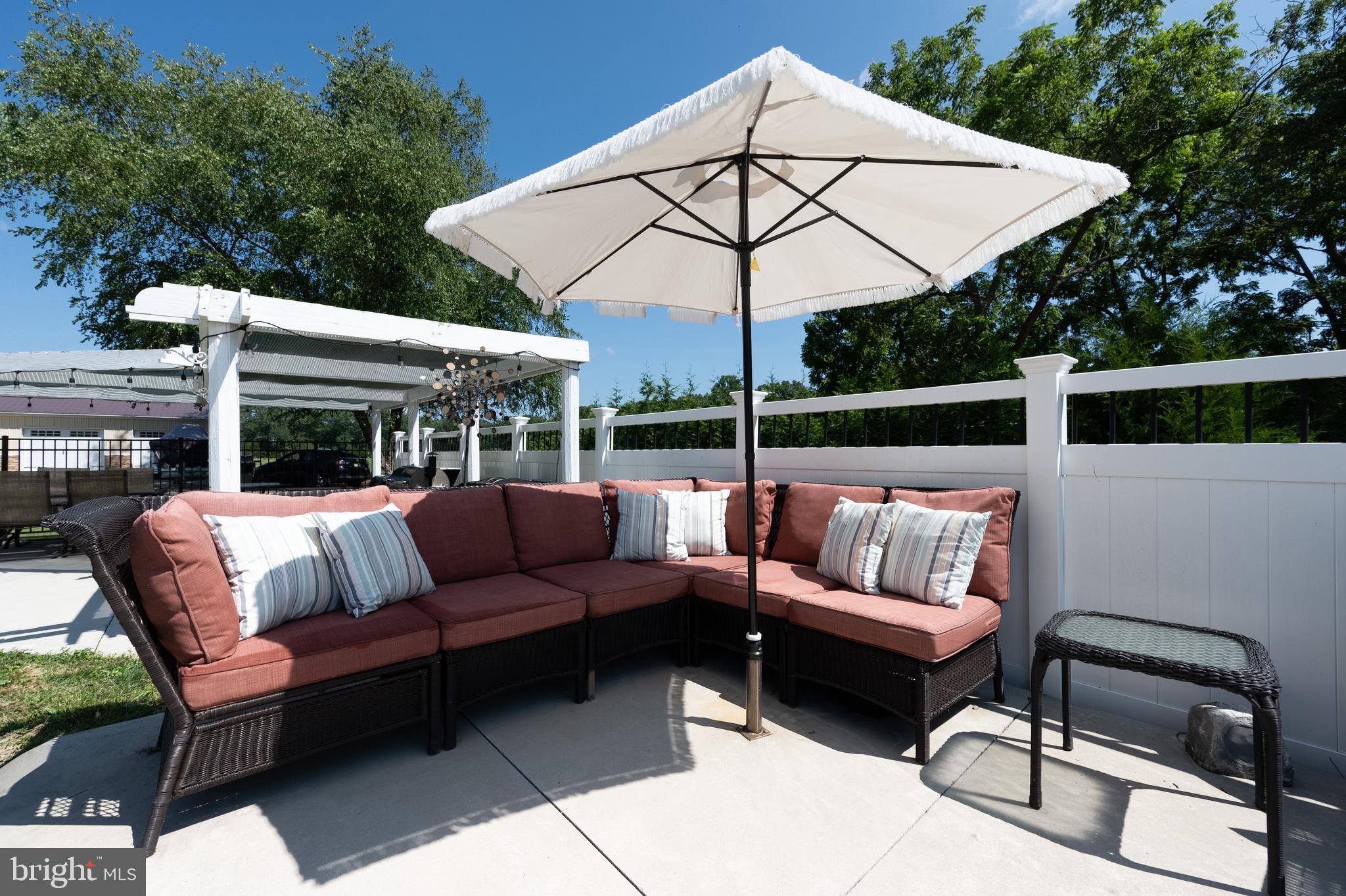 900 Elwood Road, Unit MULLICA Hammonton, NJ 08037 - Photo 47 of 56 a view of a patio with couches chairs under an umbrella