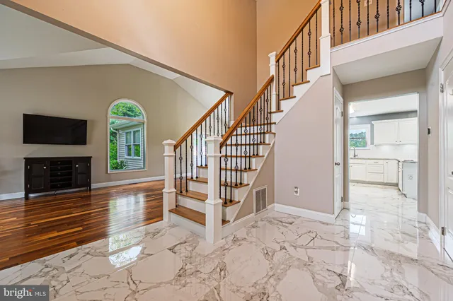 a view of entryway livingroom and hall with wooden floor
