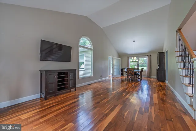 a view of a livingroom with furniture hardwood floor and a flat screen tv