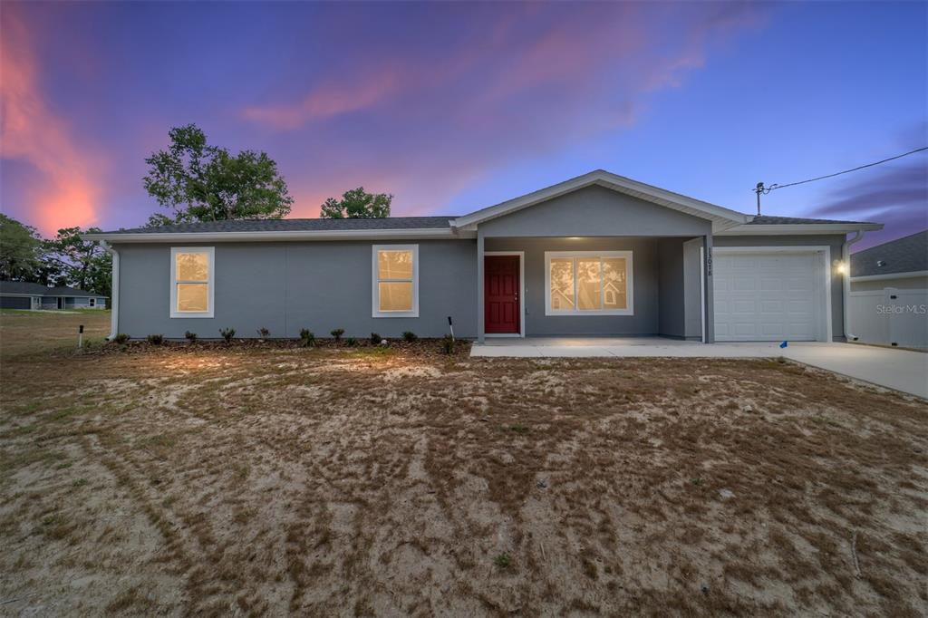 13078 Northeast 7th Loop Silver Springs, FL 34488 - Photo 1 of 56 a front view of a house with a garden