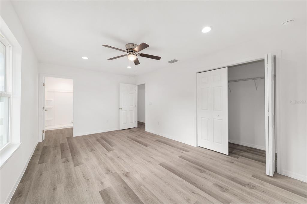13078 Northeast 7th Loop Silver Springs, FL 34488 - Photo 29 of 56 a view of empty room with wooden floor and fan
