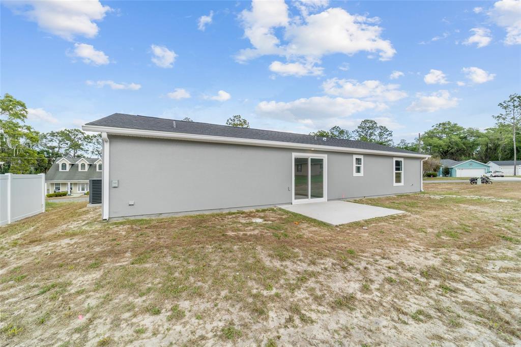13078 Northeast 7th Loop Silver Springs, FL 34488 - Photo 40 of 56 a view of a house with a backyard and a tree