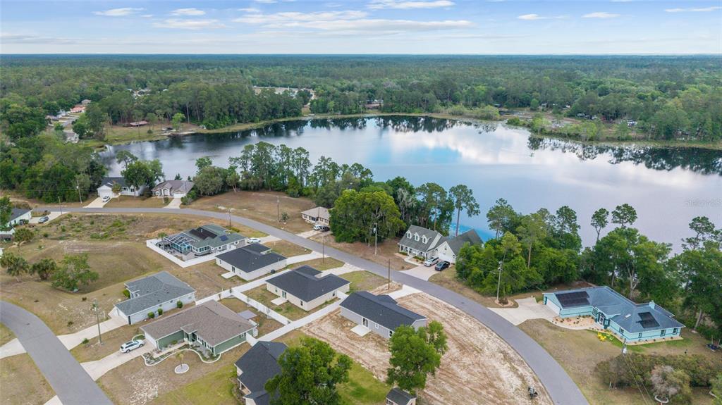 13078 Northeast 7th Loop Silver Springs, FL 34488 - Photo 49 of 56 an aerial view of a house with garden space and lake view