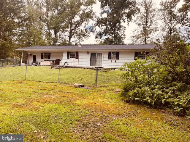 a front view of house with yard slide and outdoor seating