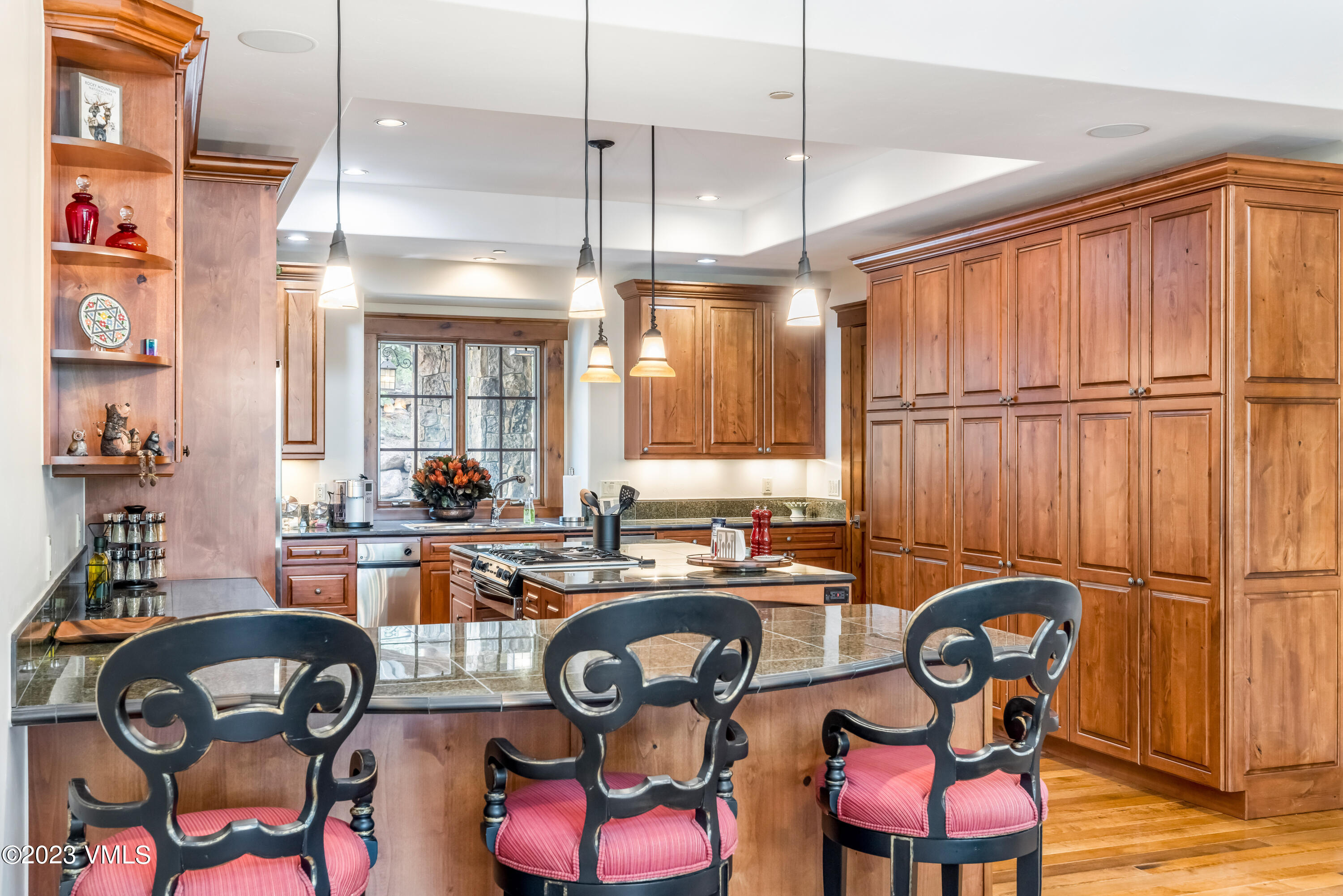 181 Summit Trail Edwards, CO 81632 - Photo 16 of 40 a kitchen with stainless steel appliances granite countertop a stove a refrigerator and a dining table with the kitchen view