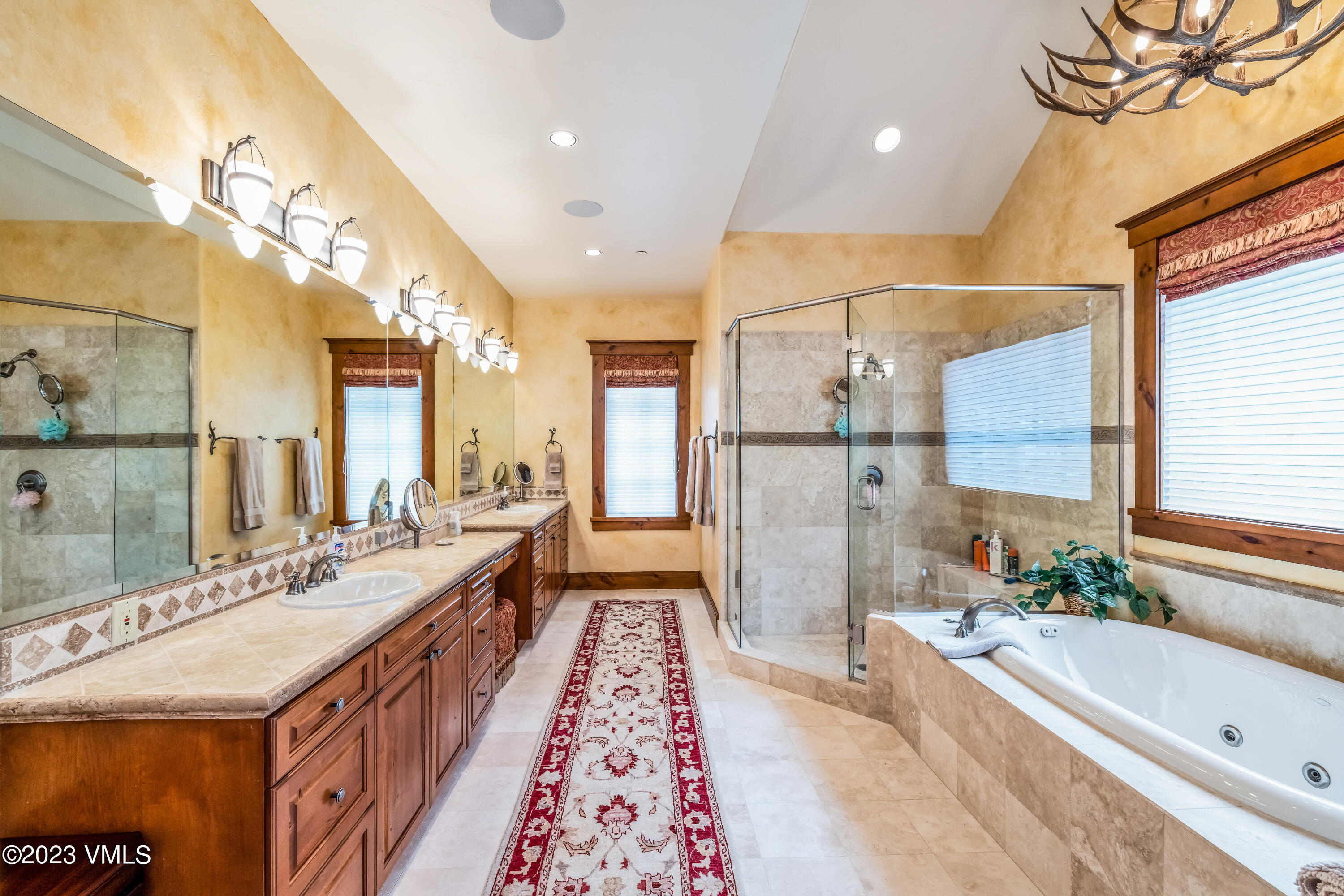 181 Summit Trail Edwards, CO 81632 - Photo 20 of 40 a spacious bathroom with a double vanity sink and a bathtub