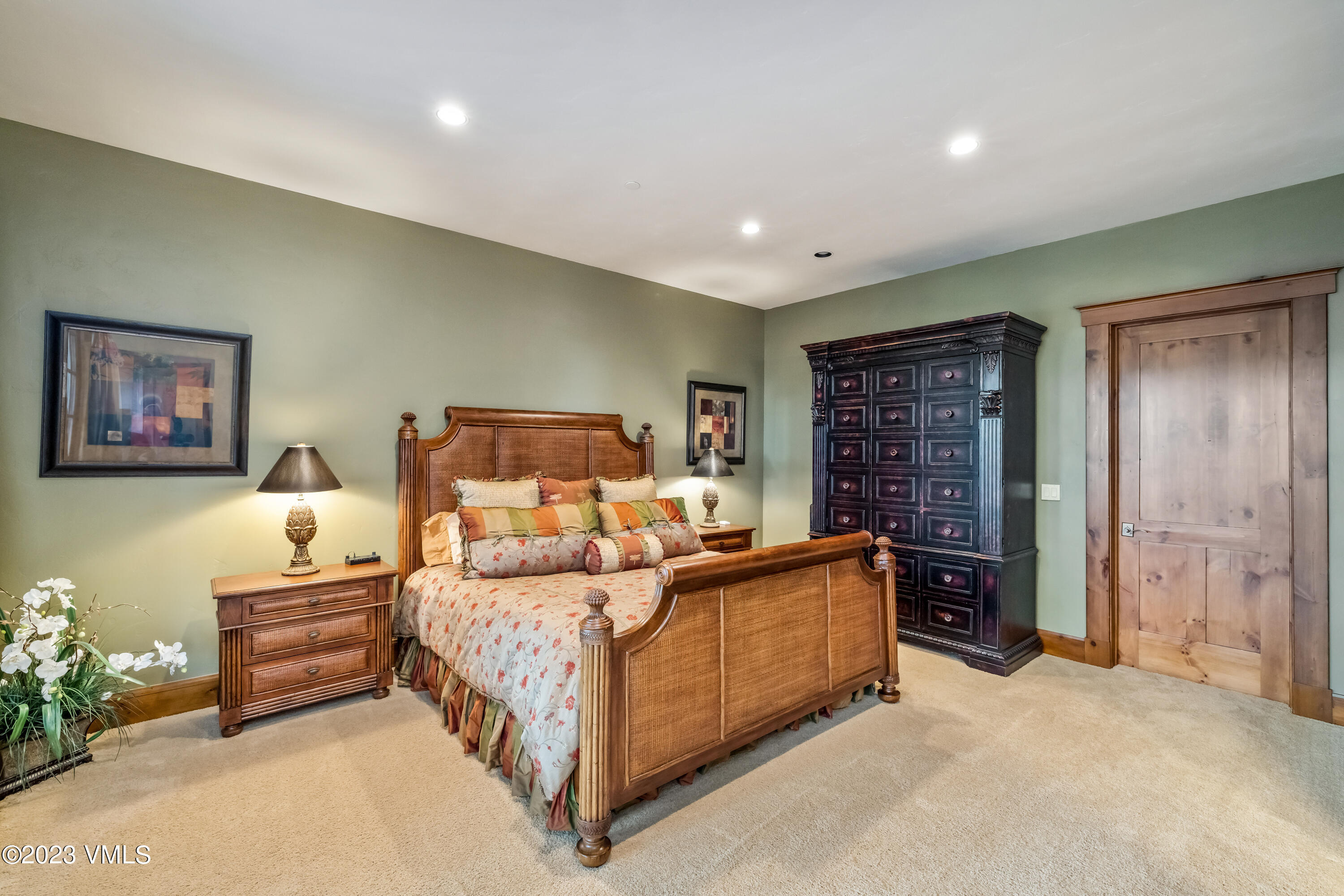 181 Summit Trail Edwards, CO 81632 - Photo 25 of 40 a bedroom with a bed and a chandelier