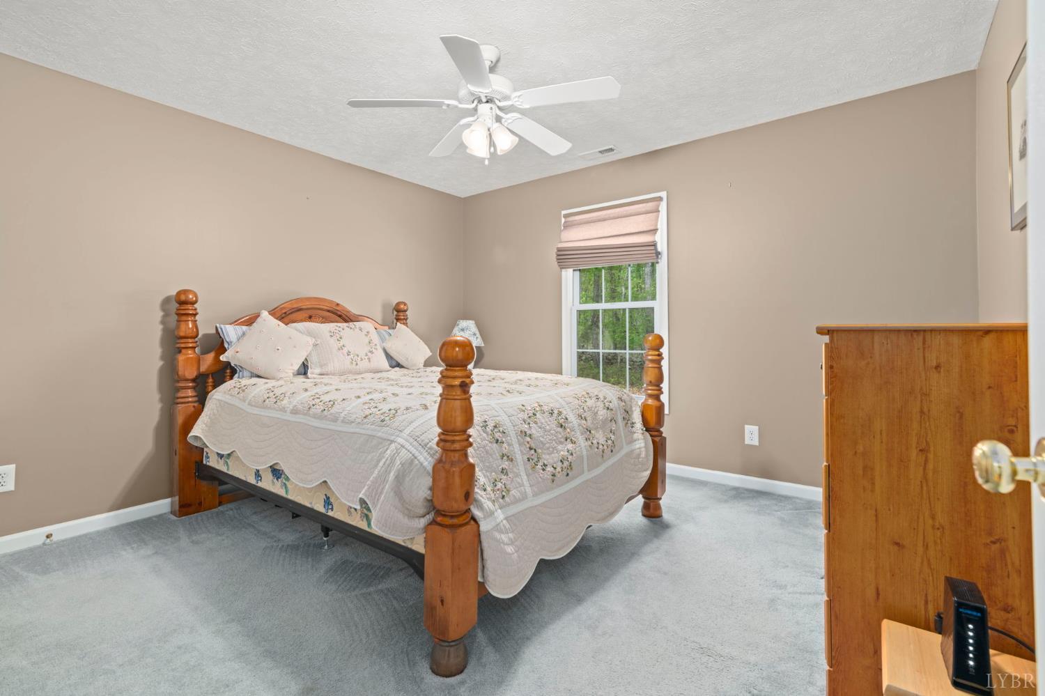 298 Braxton Ridge Road Amherst, VA 24521 - Photo 31 of 65 a bed sitting in a bedroom next to a window