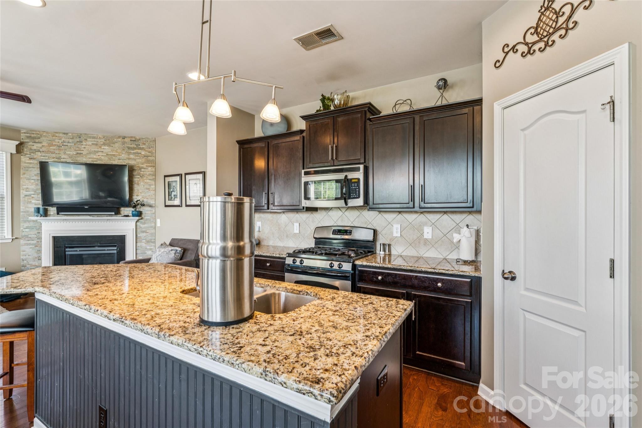 8211 Viewpoint Lane Cornelius, NC 28031 - Photo 11 of 28 a kitchen with stainless steel appliances granite countertop a sink a stove and a refrigerator