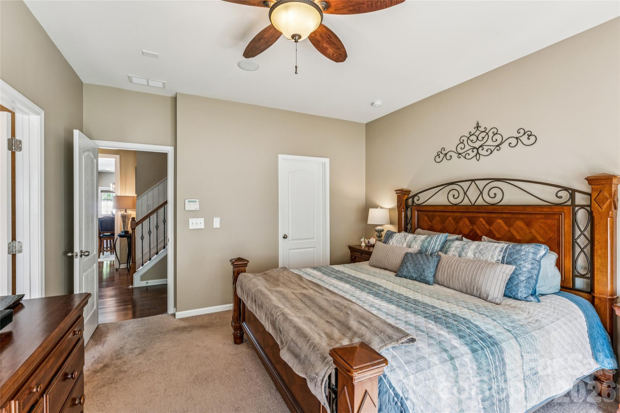 8211 Viewpoint Lane Cornelius, NC 28031 - Photo 13 of 28 a bedroom with a bed and a chandelier