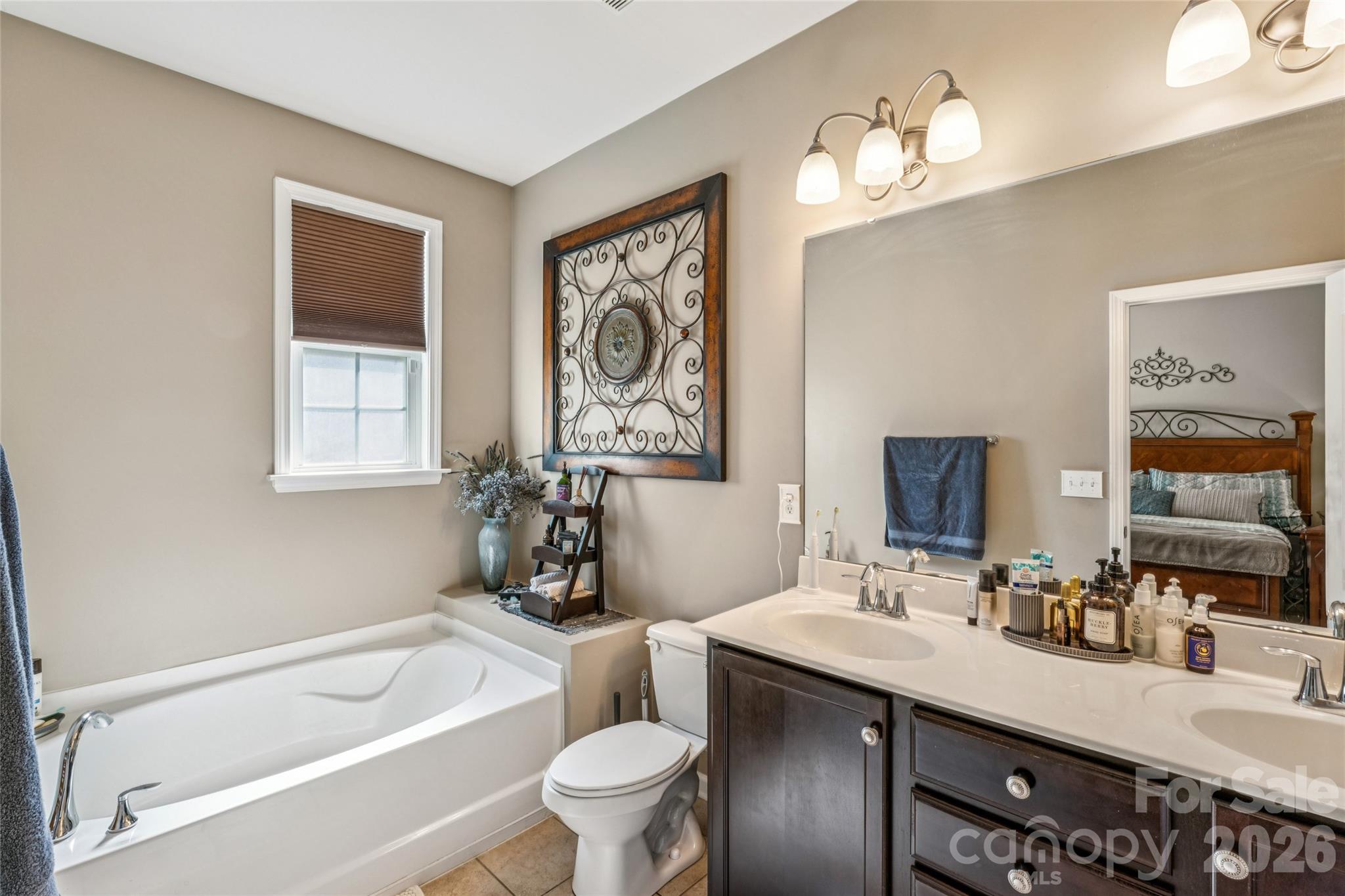 8211 Viewpoint Lane Cornelius, NC 28031 - Photo 14 of 28 a bathroom with a granite countertop sink a toilet a mirror and shower