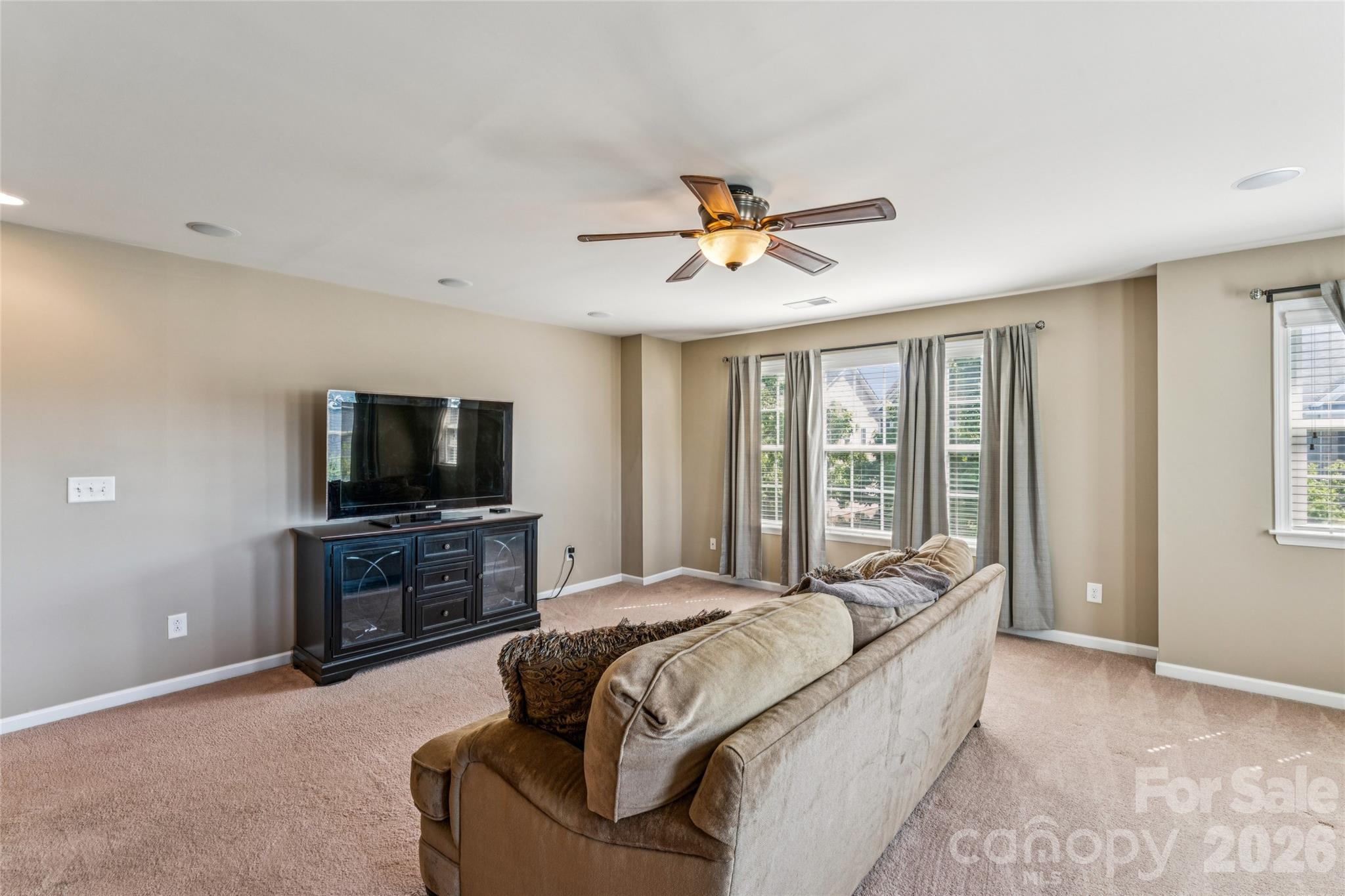 8211 Viewpoint Lane Cornelius, NC 28031 - Photo 16 of 28 a spacious bedroom with a bed and a flat screen tv