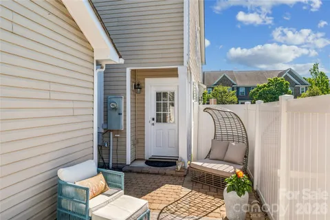 a view of a patio with couple of chairs and a couch