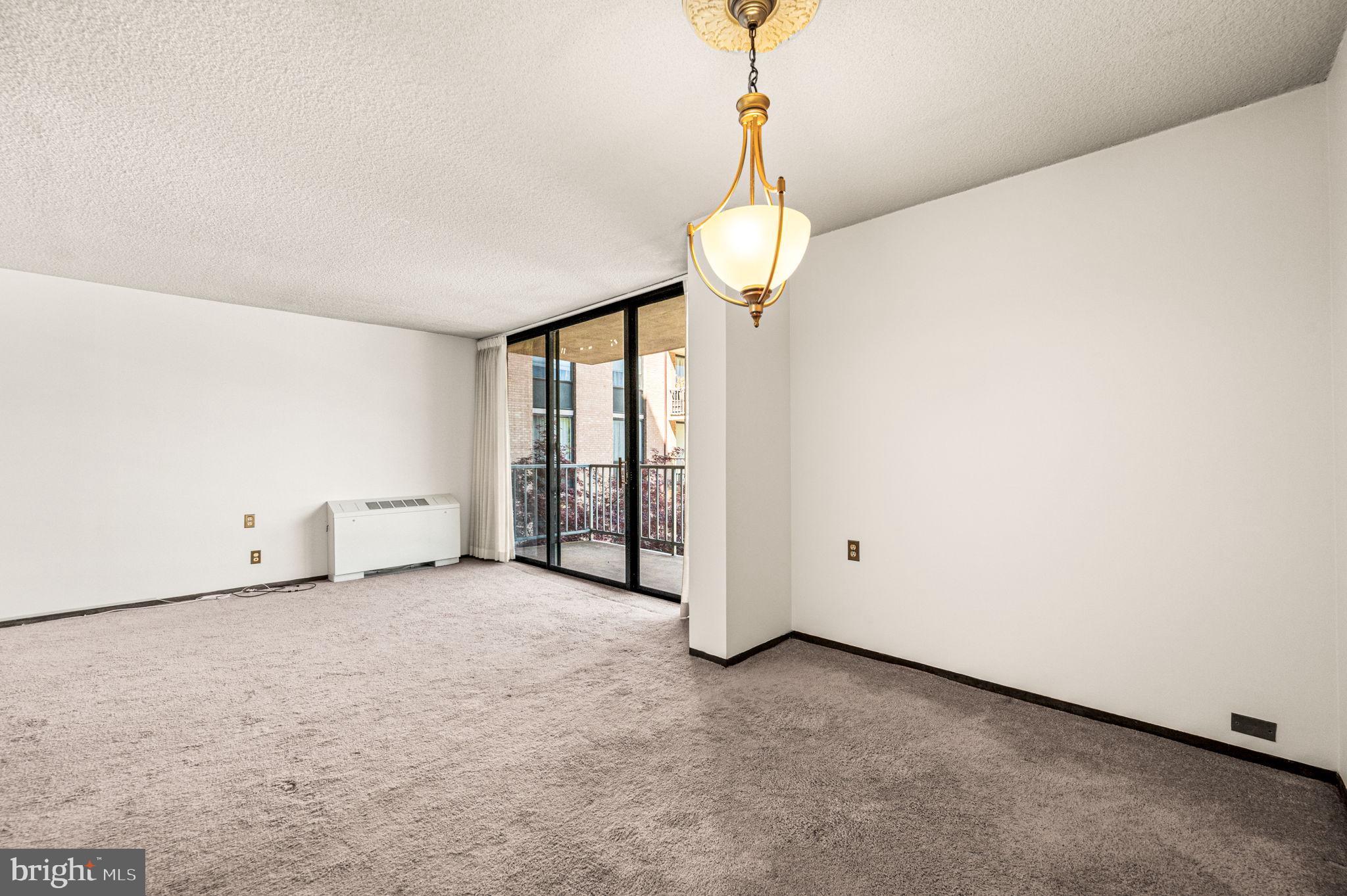 801 Yale Avenue, Unit 511 Swarthmore, PA 19081 - Photo 8 of 28 a view of an empty room with a chandelier