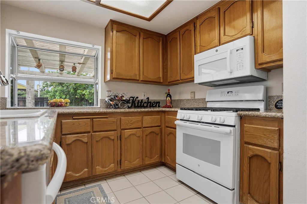 25497 Blackwood Road Murrieta, CA 92563 - Photo 11 of 44 a kitchen with stainless steel appliances granite countertop white cabinets sink and a granite counter top