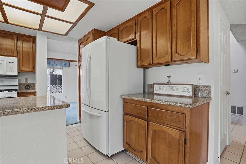 25497 Blackwood Road Murrieta, CA 92563 - Photo 12 of 44 a kitchen with stainless steel appliances granite countertop a refrigerator and a sink