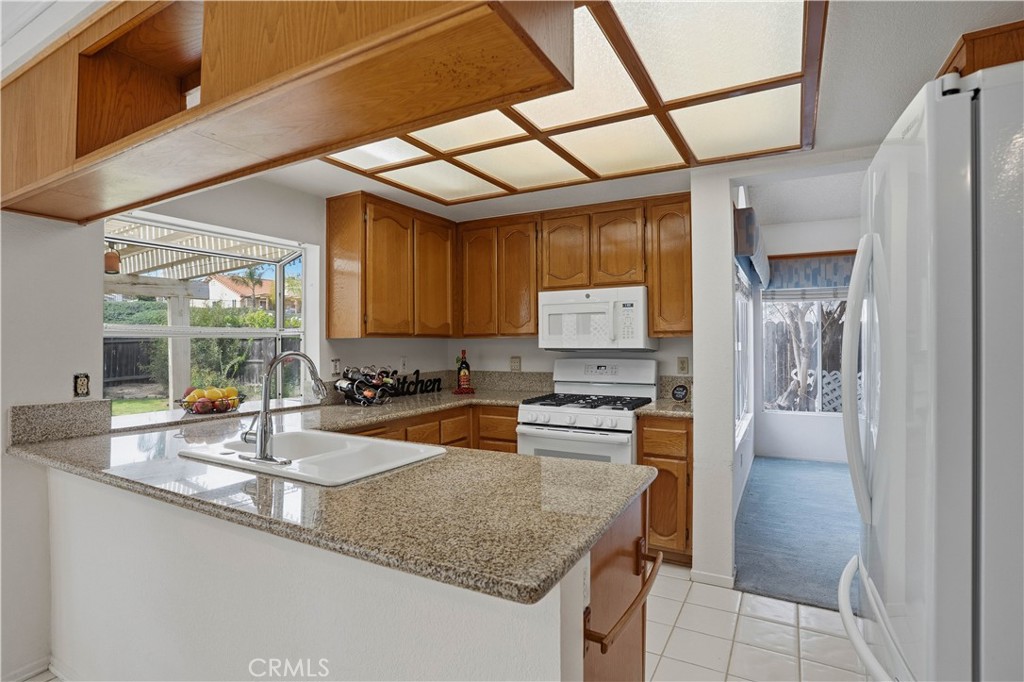 25497 Blackwood Road Murrieta, CA 92563 - Photo 13 of 44 a kitchen with stainless steel appliances granite countertop a sink stove and cabinets