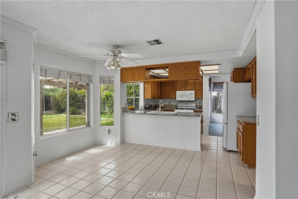 25497 Blackwood Road Murrieta, CA 92563 - Photo 16 of 44 a kitchen with a refrigerator and a sink