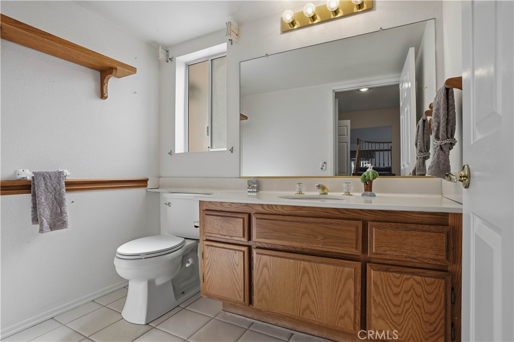 25497 Blackwood Road Murrieta, CA 92563 - Photo 21 of 44 a bathroom with a sink toilet and mirror