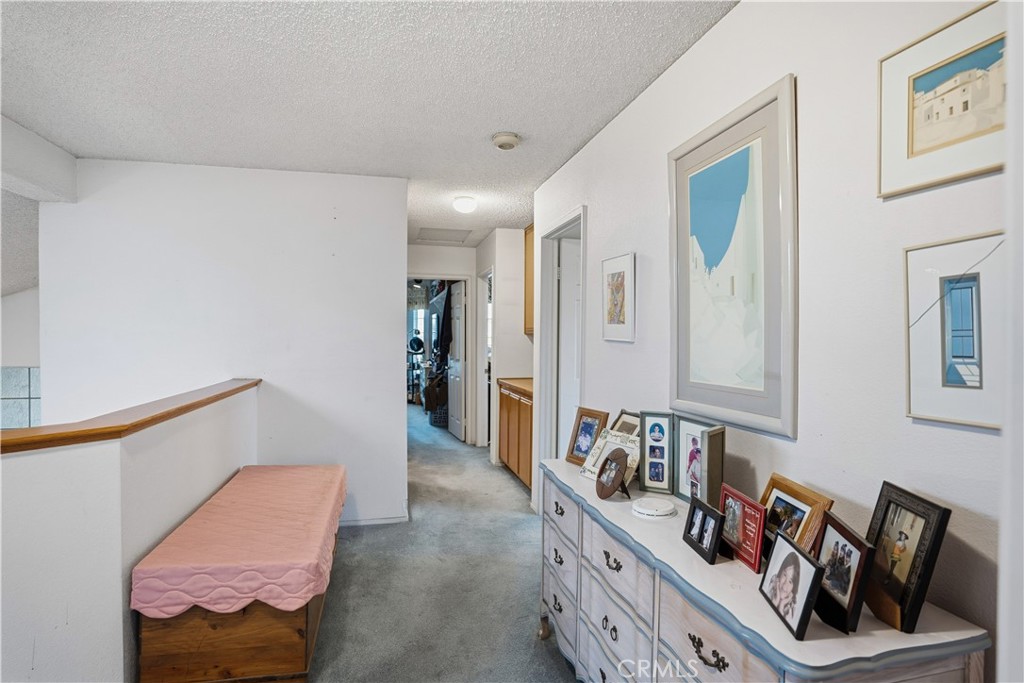 25497 Blackwood Road Murrieta, CA 92563 - Photo 23 of 44 a hallway with furniture and a book shelf