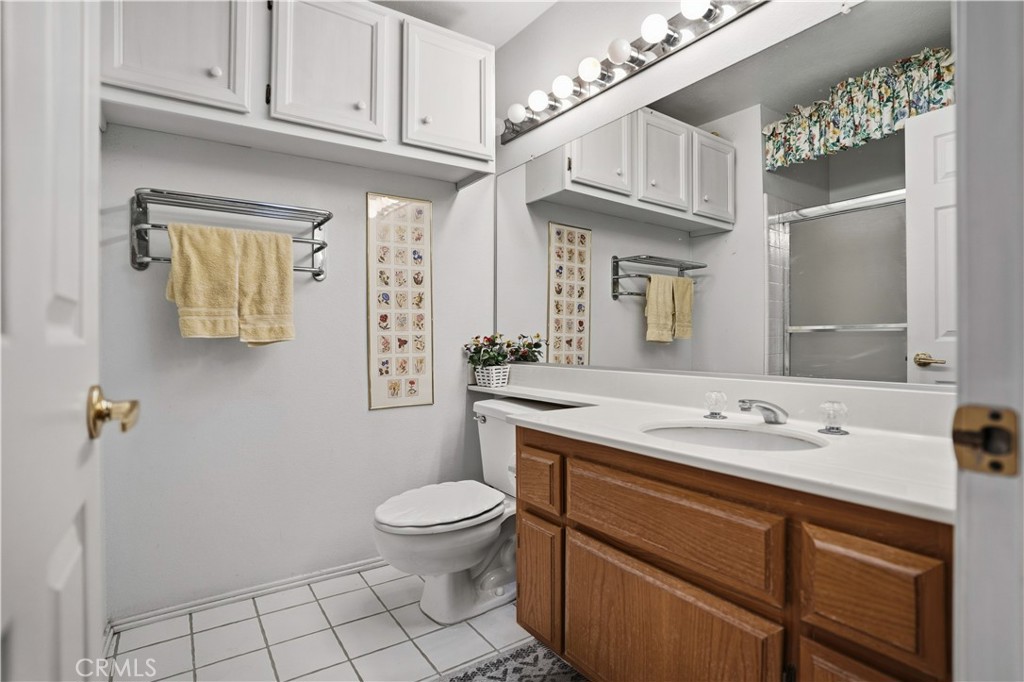 25497 Blackwood Road Murrieta, CA 92563 - Photo 25 of 44 a bathroom with a granite countertop toilet sink and mirror
