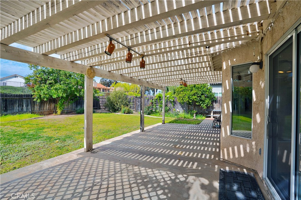 25497 Blackwood Road Murrieta, CA 92563 - Photo 31 of 44 a view of a patio with a table and chairs next to a yard