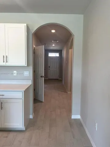 a view of hallway with chandelier