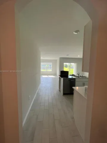 a view of a room with a sink and a bed