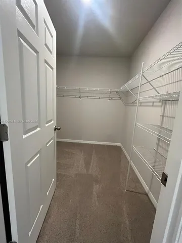 a bathroom with a granite countertop toilet and a shower