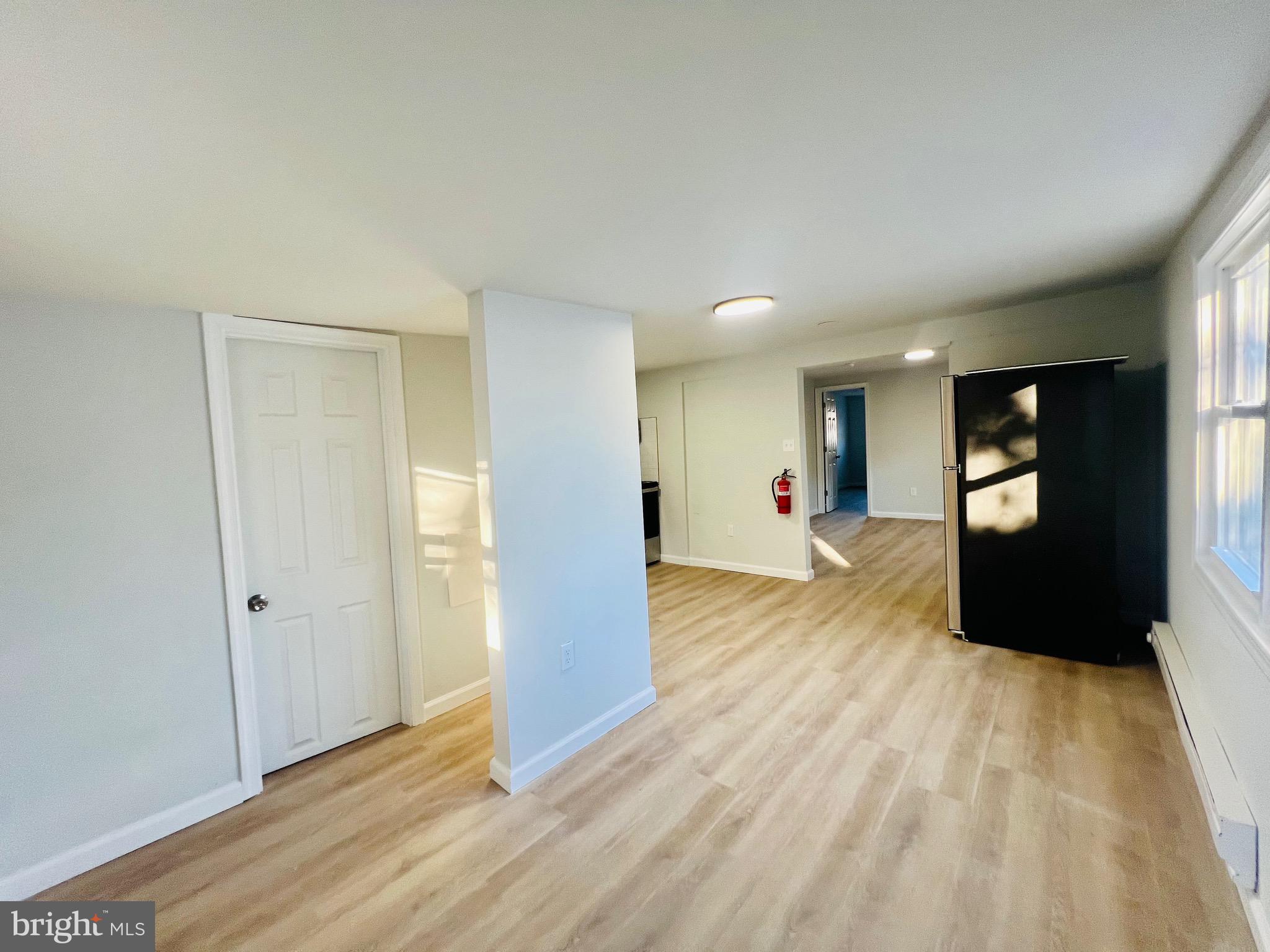 401 Blue Bell Road, Unit E Williamstown, NJ 08094 - Photo 6 of 11 a view of a big room with wooden floor and windows