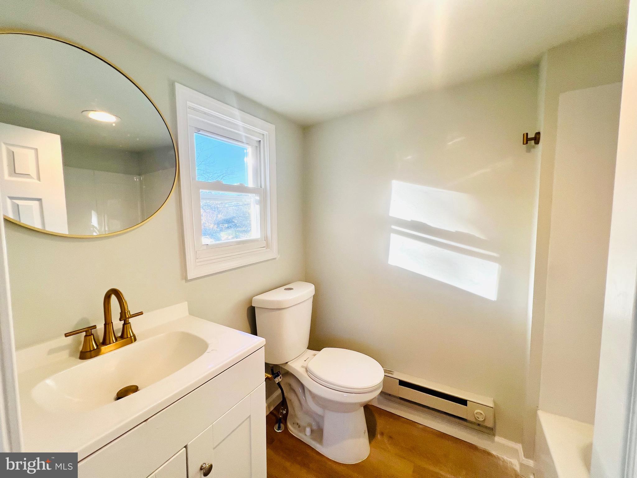 401 Blue Bell Road, Unit E Williamstown, NJ 08094 - Photo 8 of 11 a white toilet sitting next to a bathroom sink
